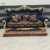 Teak wood 3 seater sofa with golden and black deco polish in living room