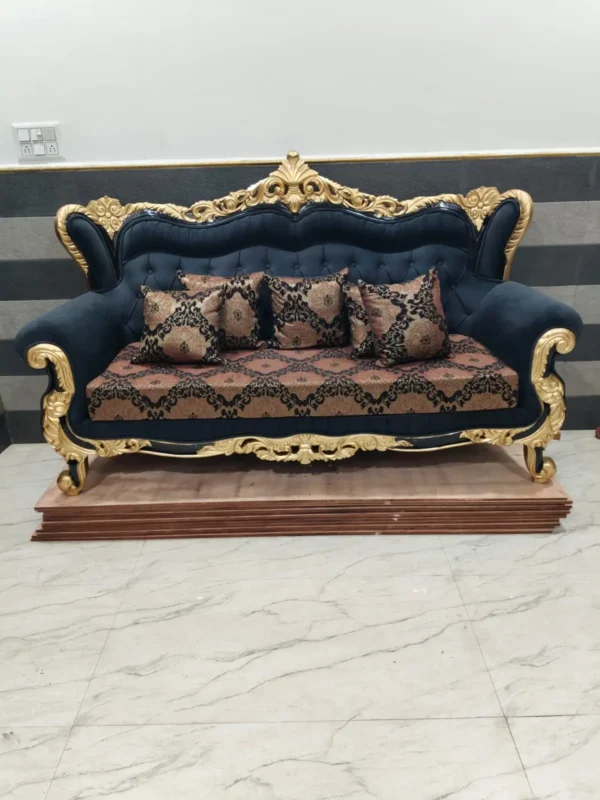 Teak wood 3 seater sofa with golden and black deco polish in living room