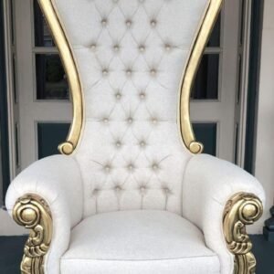 King and Queen high back throne chair in gold leaf and white leatherette "A majestic high-back armchair featuring an intricate antique gold-painted wooden frame with a crown-like crest and plush white button-tufted cushions."