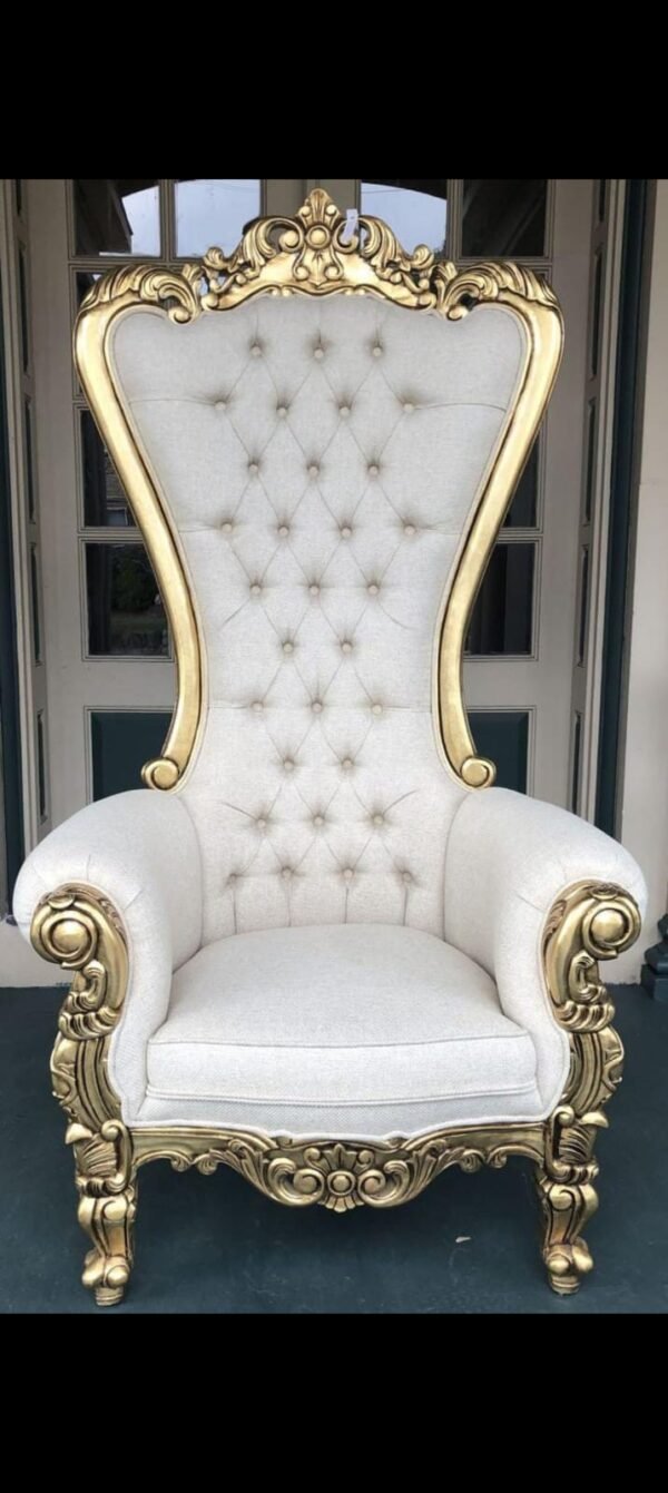 King and Queen high back throne chair in gold leaf and white leatherette "A majestic high-back armchair featuring an intricate antique gold-painted wooden frame with a crown-like crest and plush white button-tufted cushions."