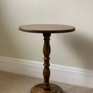 Solid wood round pedestal accent table with a walnut finish and classic turned wood design.