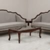 Luxury premium wooden sofa set with premium beige fabric upholstery, handcrafted detailing, elegant center table, and royal living room furniture design.