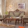 Luxury hand carved wooden sofa set with royal floral upholstery, solid wood frame, matching armchairs, and elegant center table for premium living room interiors.