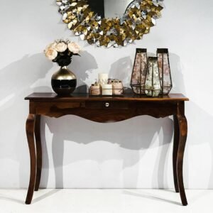 Elegant wooden console table with drawer, curved legs, and decorative items placed on top in a modern home interior setting.