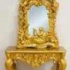 Premium teak wood furniture frame with decorative golden polish in showroom