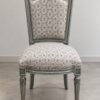 website upload Luxury French Classic Upholstered Dining Chair with carved solid wood frame, premium patterned fabric upholstery, fluted legs, and handcrafted luxury finish by The Wooden Atelier.